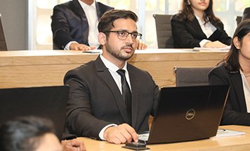 Student presenting in a seminar room