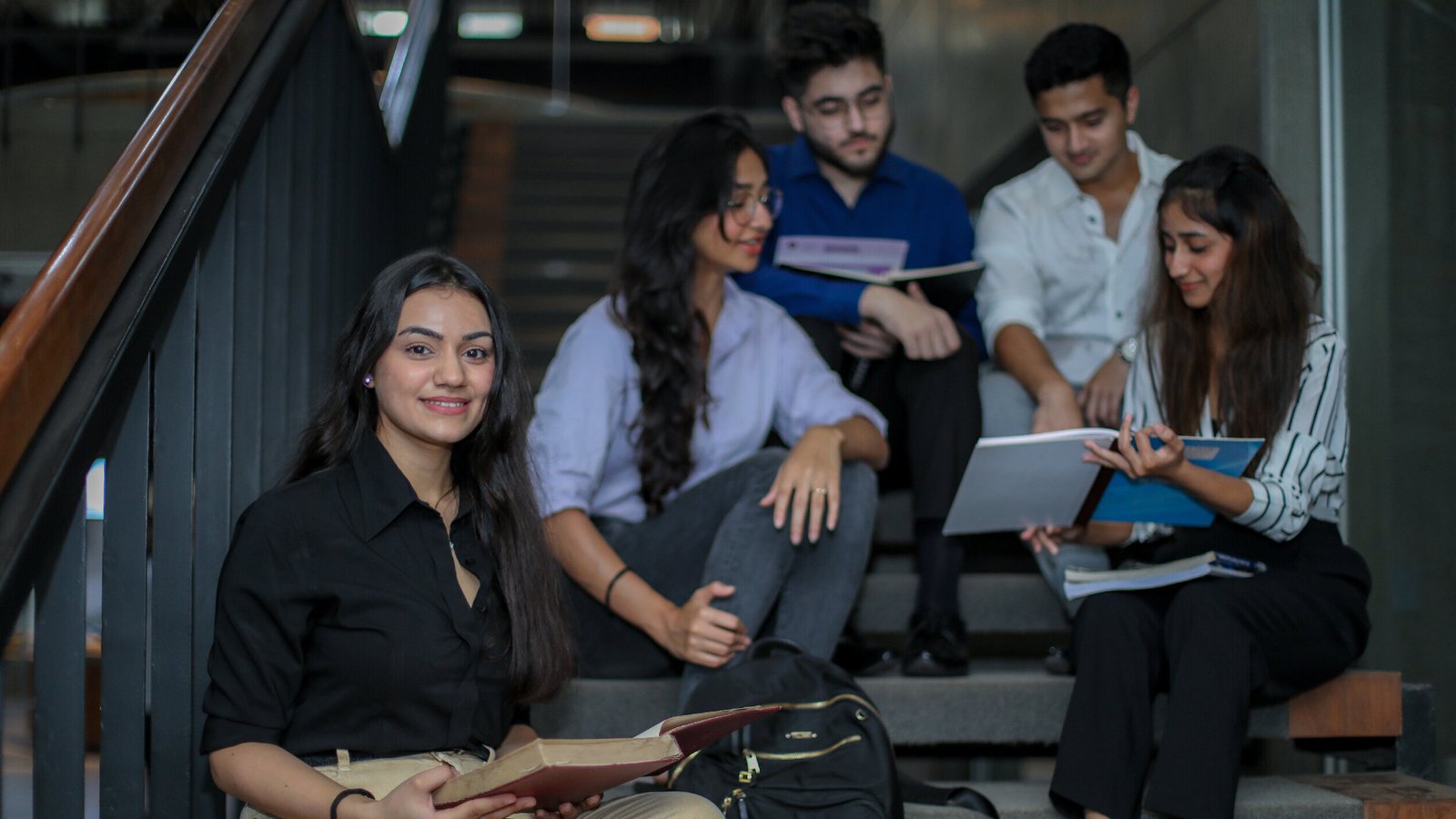 Group of students studying together on the campus staircase