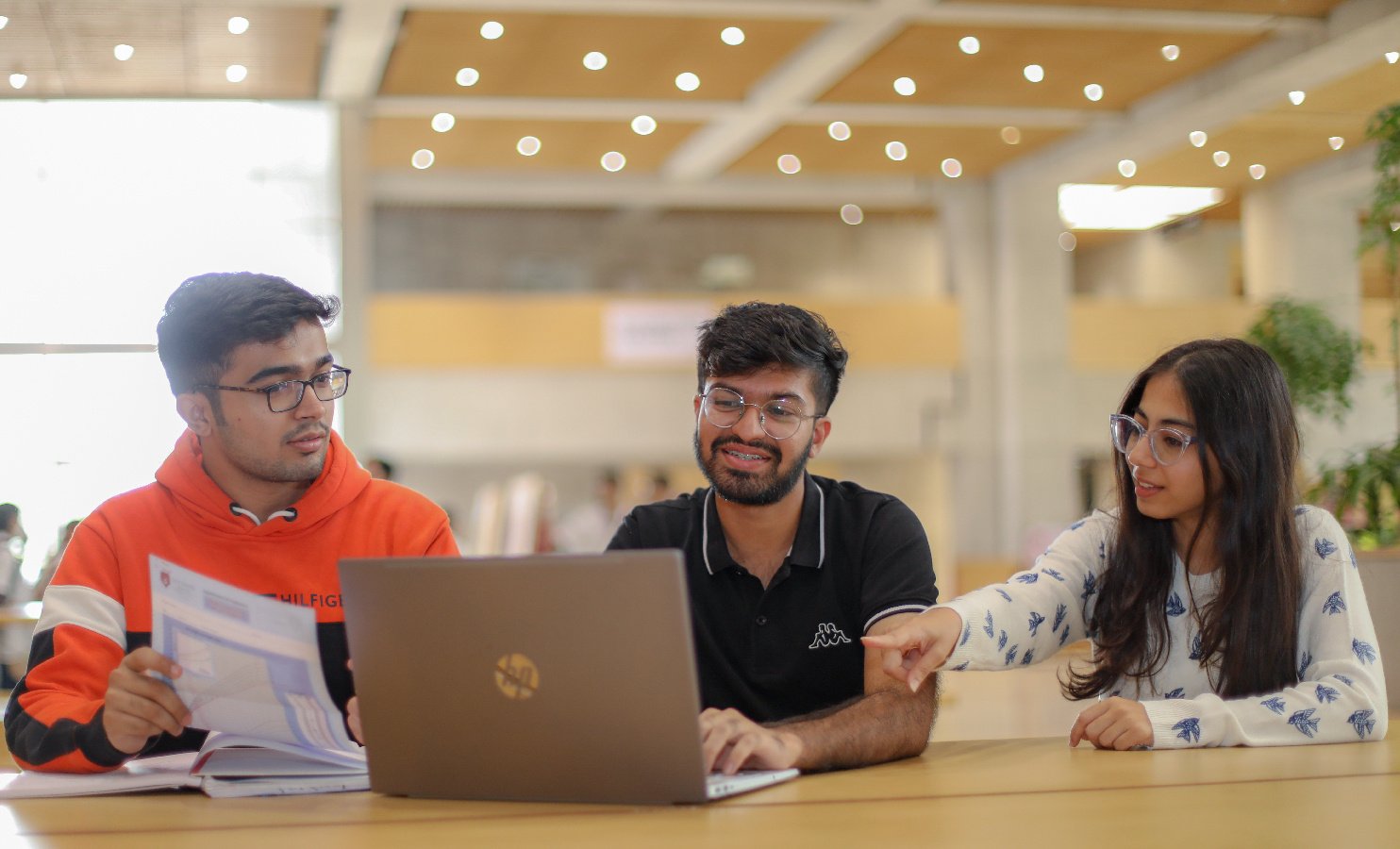 Students collaborating over a laptop